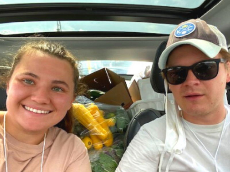 Couple in Car with Produce Filling Truck