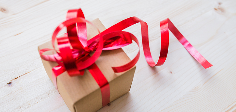 Red ribbon on brown cardboard box