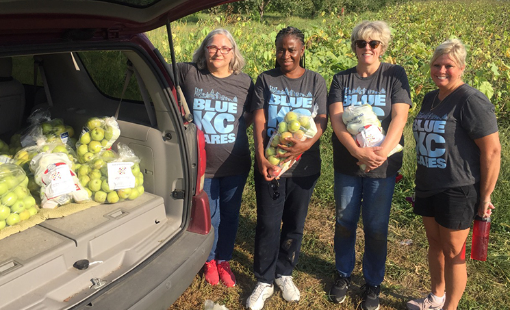 Ladies with bags of apples
